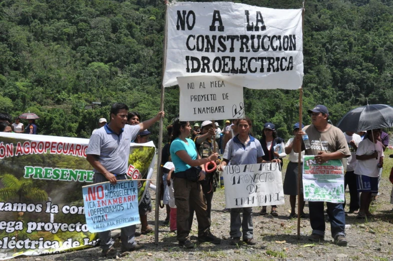 several protesters holding signs protesting contradictigaria