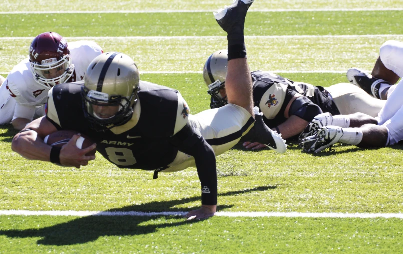 a football player falling down on the field