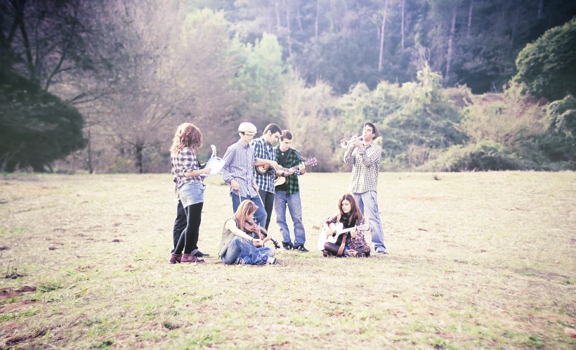 the group of friends poses in the middle of a field