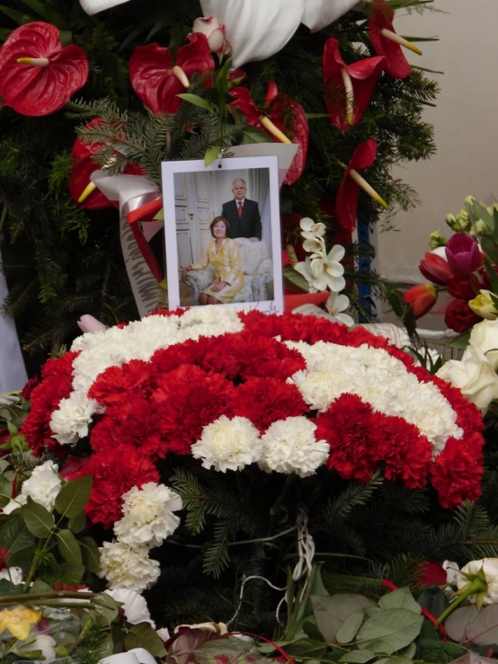 a picture of a man is placed next to some flowers