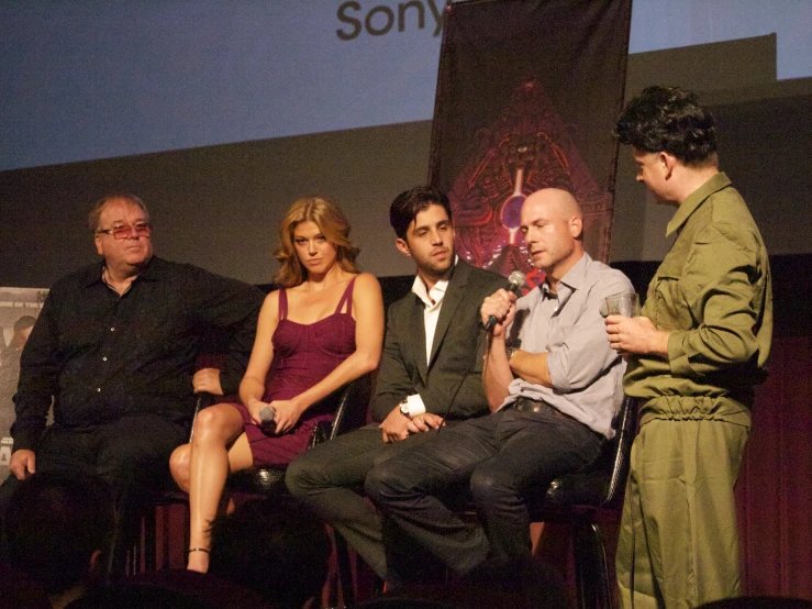 a group of people are sitting in a group and talking