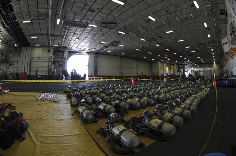 many antique motorcycles in an indoor space with lights