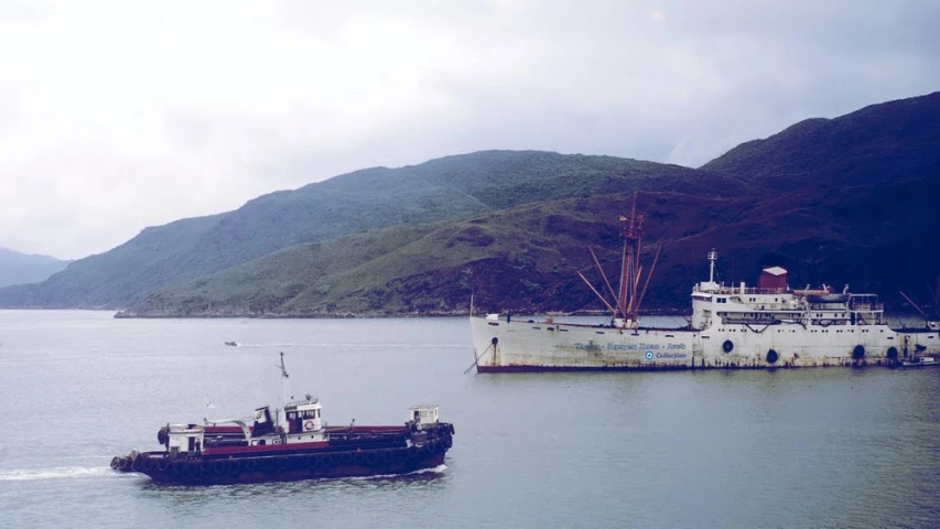 a boat that is in the water near a mountain