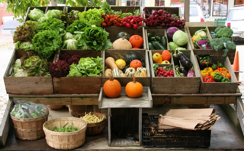 the fresh produce stand is stocked with many vegetables