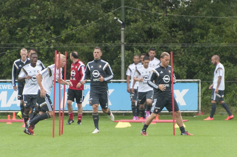 several soccer players are running around the field