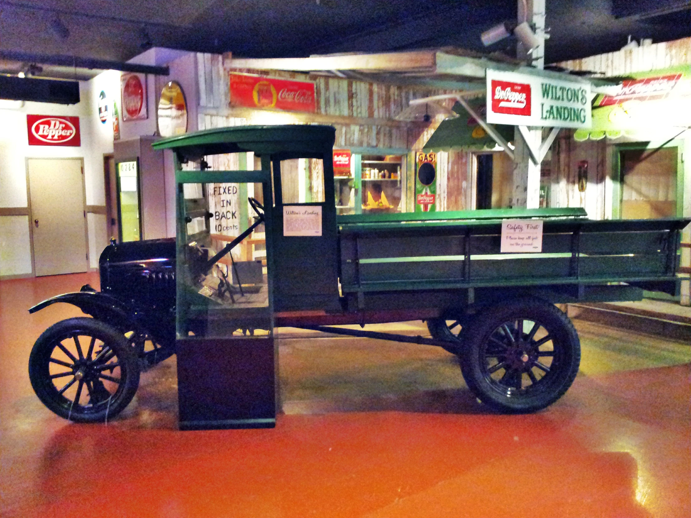 an antique vehicle is parked inside a museum display