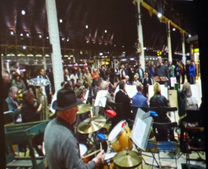 a band playing in an outdoor venue at night