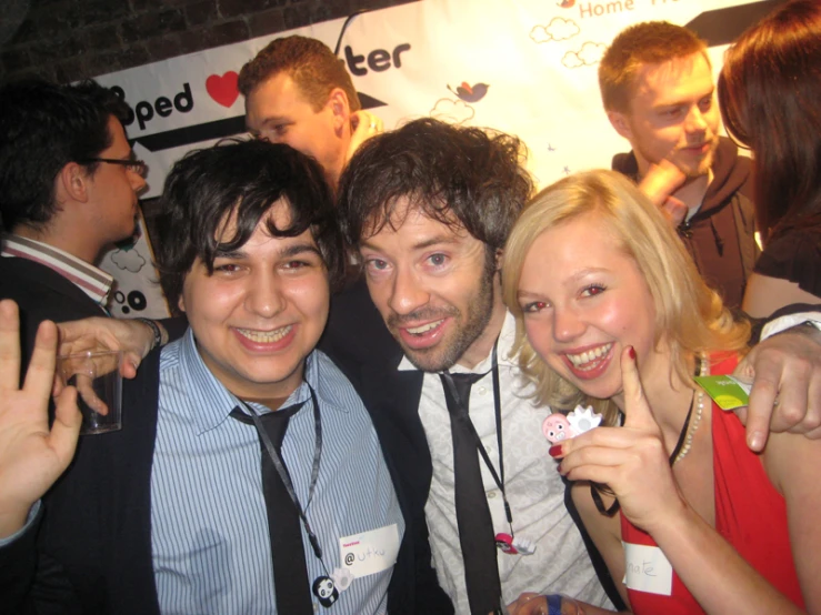 a man, woman and young man posing together at the event