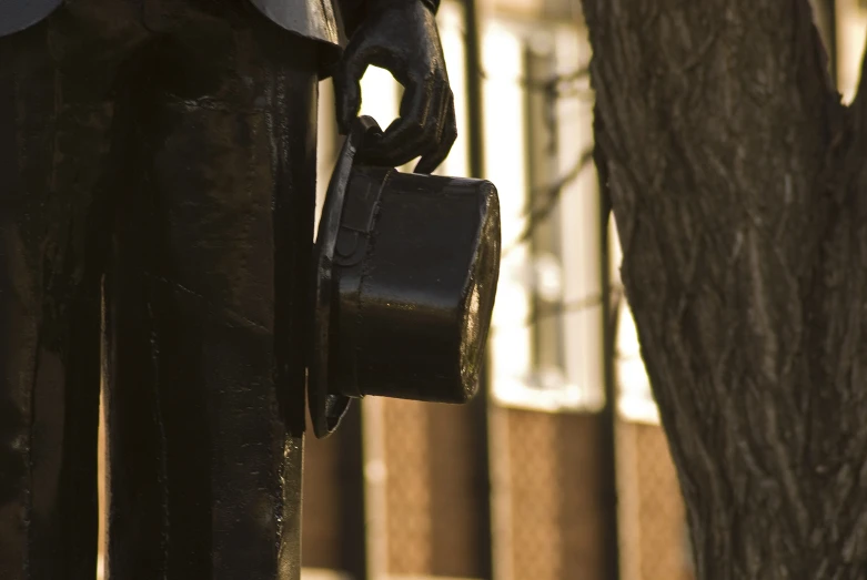 a statue of a man holding a drink bucket is shown