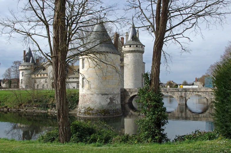 a castle sits next to a body of water