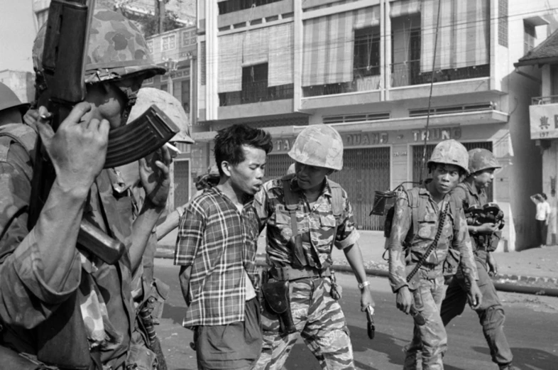 a group of soldiers and policemen marching by in an urban area