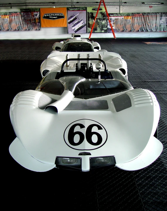 a large white and black racing car on display