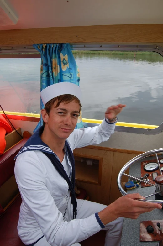 a man in a chef's hat on a boat