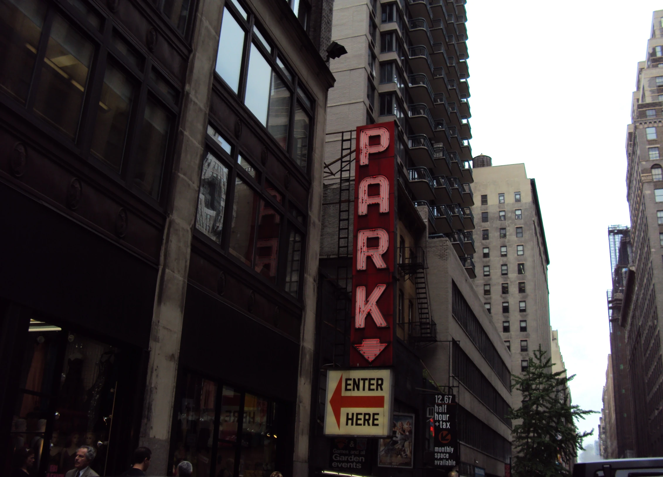 the park theater sign hangs over the sidewalk in the city