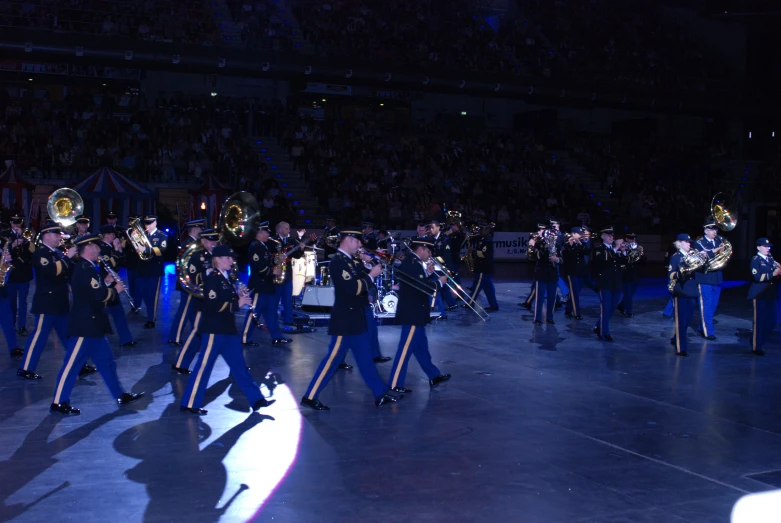 a bunch of people in uniform walking down the street