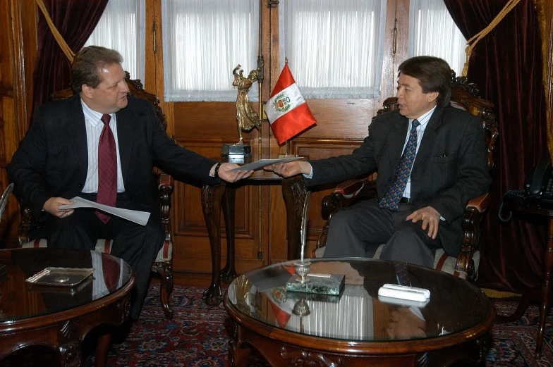 a man shaking another mans hand in a room