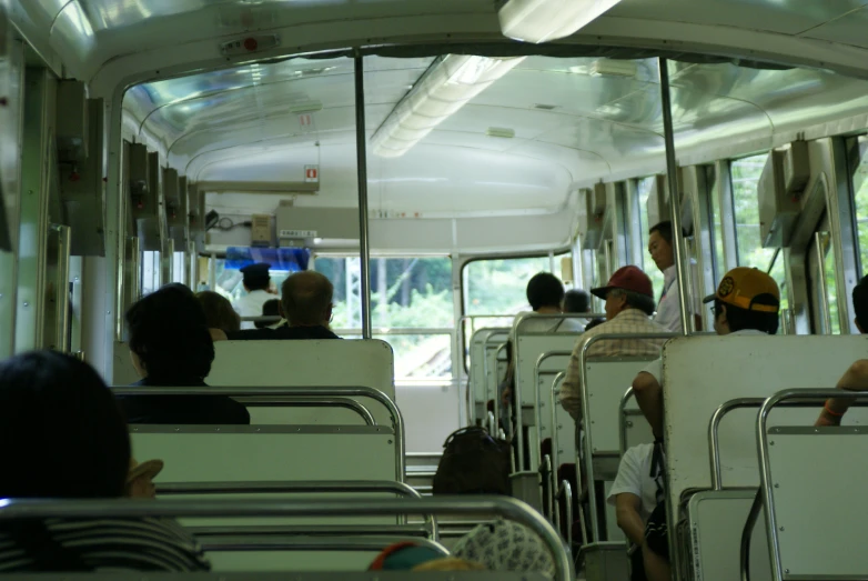 several people riding on an empty bus