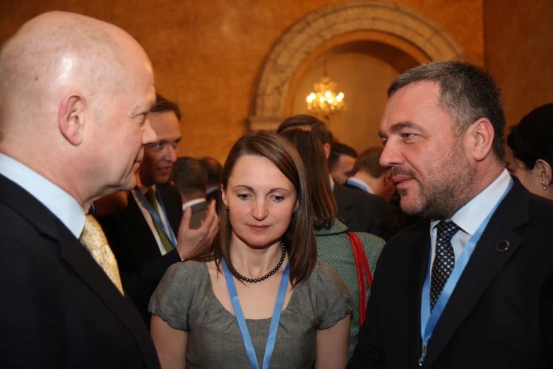 three people at a business meeting wearing suits and ties