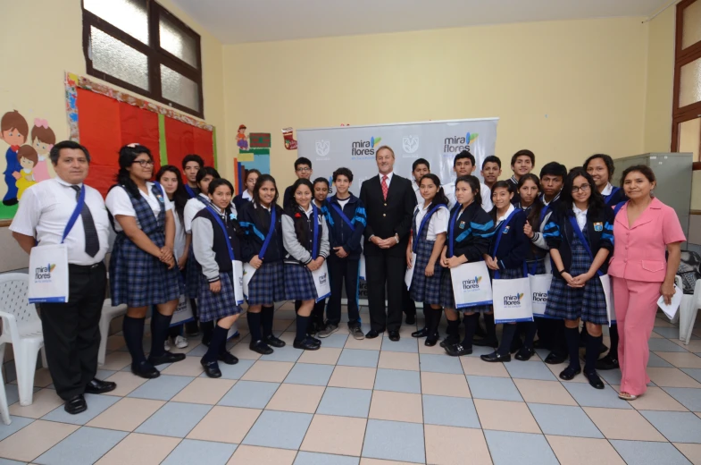 a group of young people dressed in school uniforms with school children