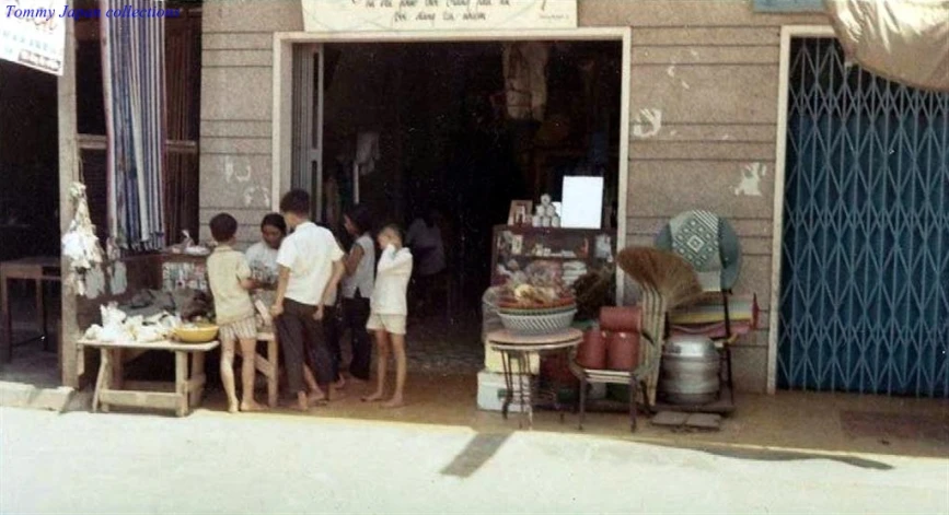 group of people gathered outside a small shop
