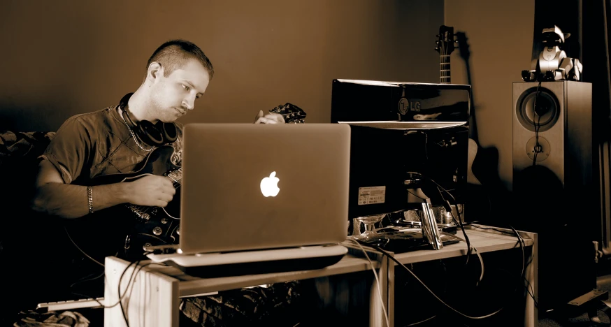 a man sitting in front of a laptop computer