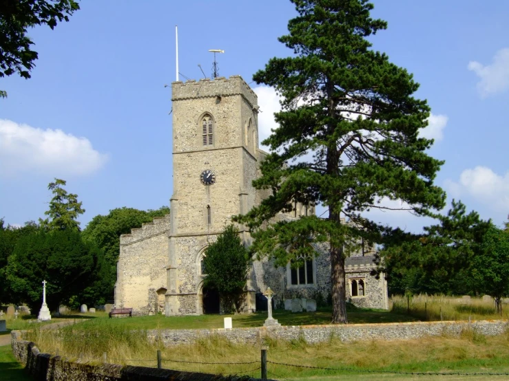 a large church surrounded by a forest filled with trees