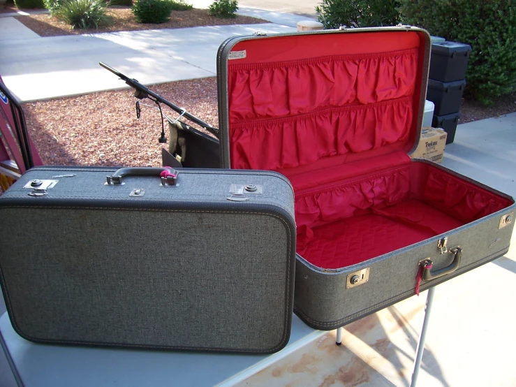 suitcases sit outside on a bench by a pole