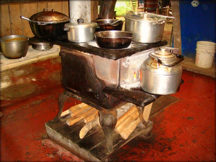 the pot is sitting on the small stove