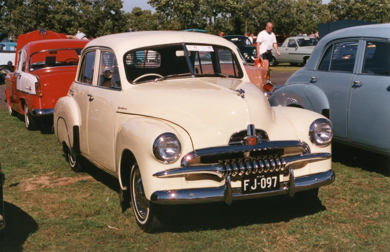 a line of vintage cars at a car show