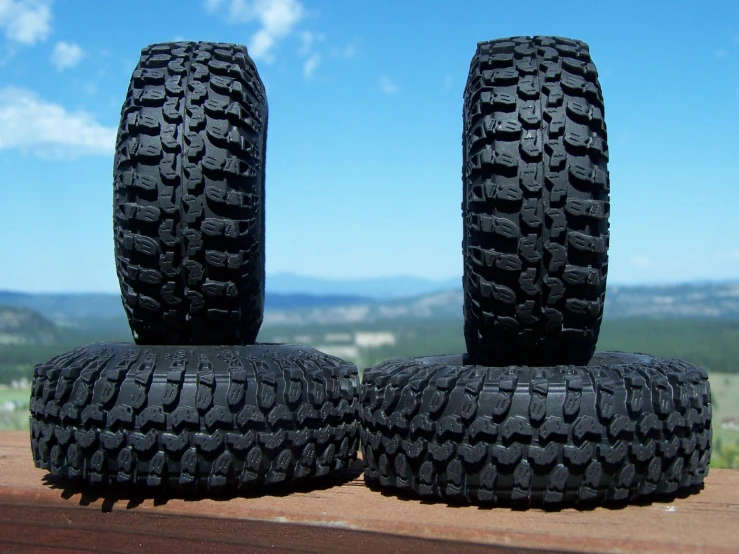 there are four black tires that are stacked on top of each other