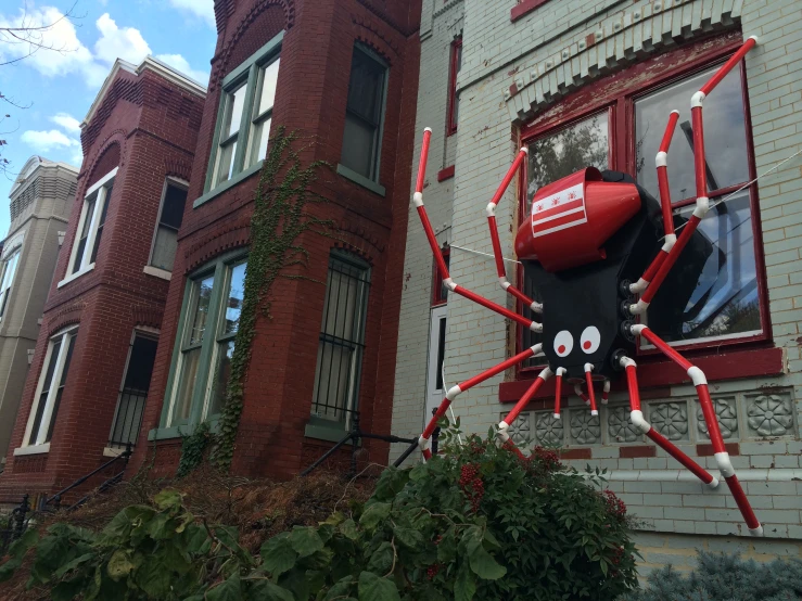 a giant spider prop sitting on top of a window