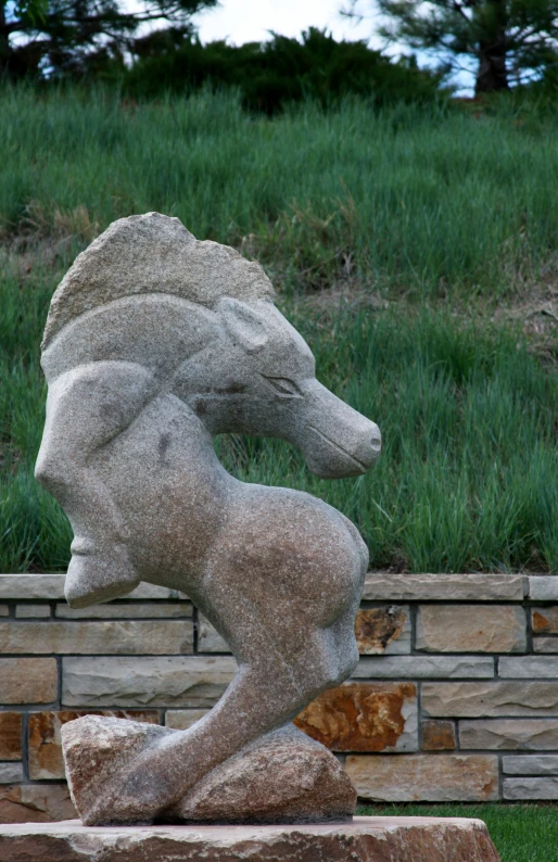a stone lion statue on top of a block wall