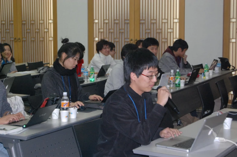 several people at their computers in an asian seminar