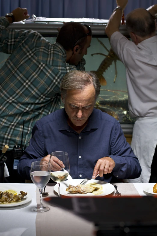 the man is eating a meal at his dining table