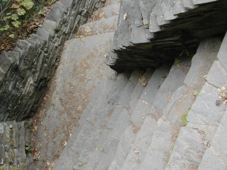 there is an upturned stone building on the mountain