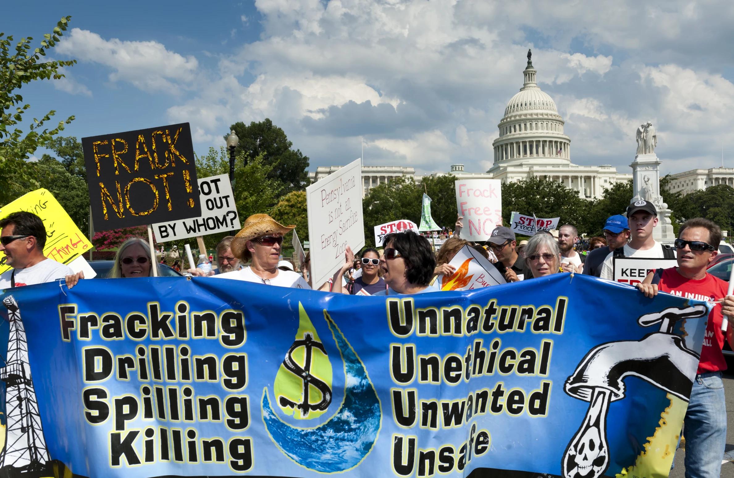 a crowd of people with signs in front of the us capitol building