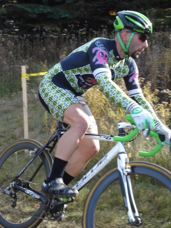 a cyclist dressed in safety gear and riding a bike