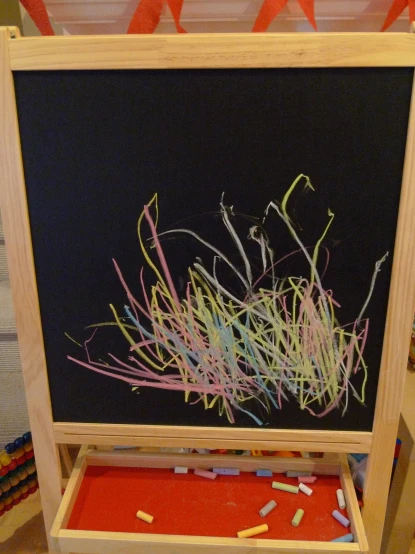 a child's chalk board made from various items