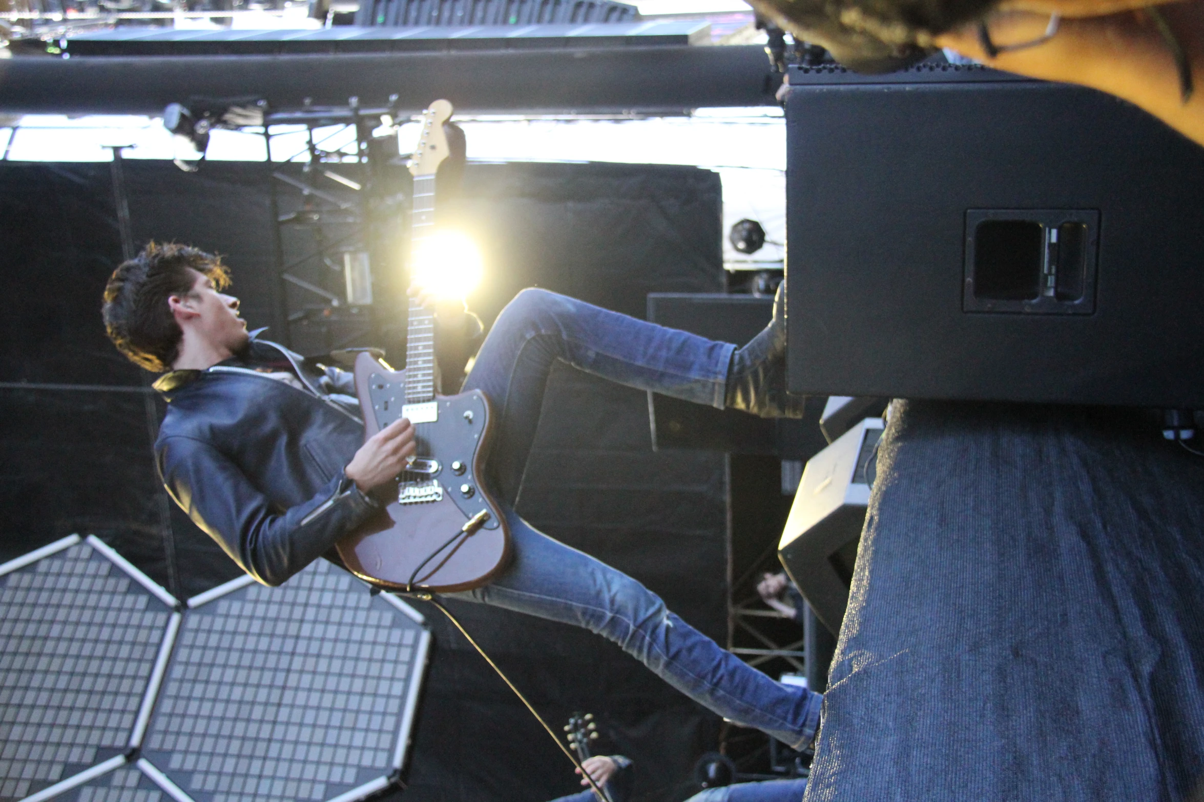 a man singing and playing guitar on a stage