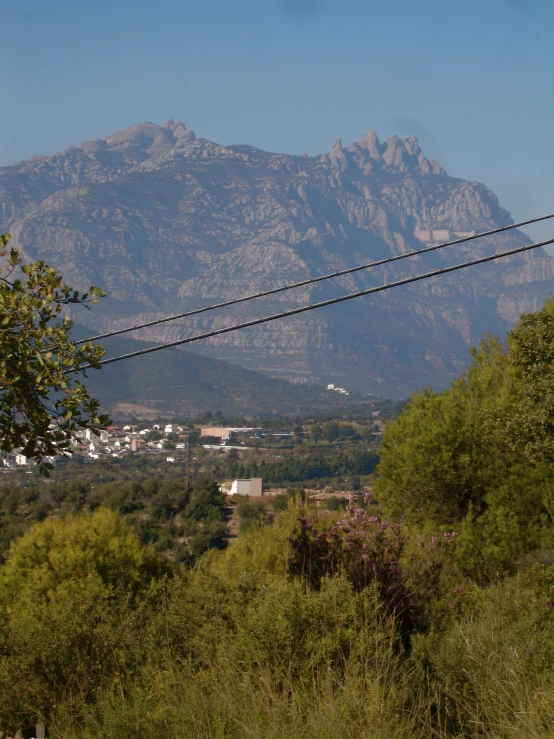 a mountain is behind some wires in the foreground