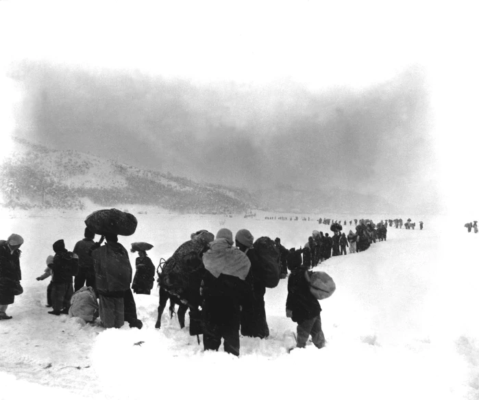 a crowd of people is standing in the snow