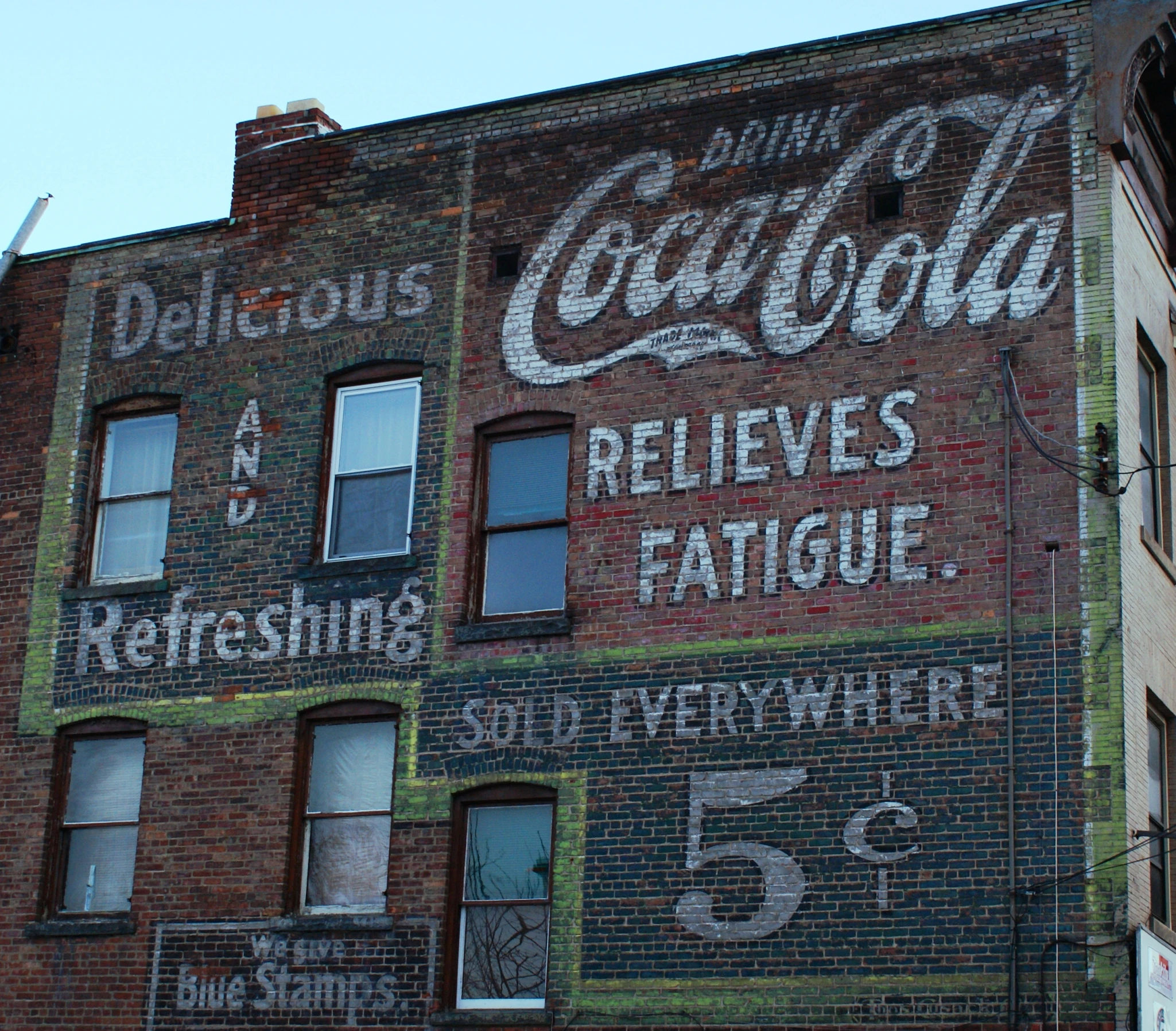 an old building has signs painted on the side