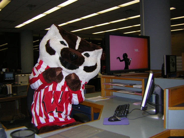 a person in a costume on a desk next to a television