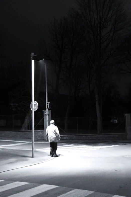 a man walking in the street at night