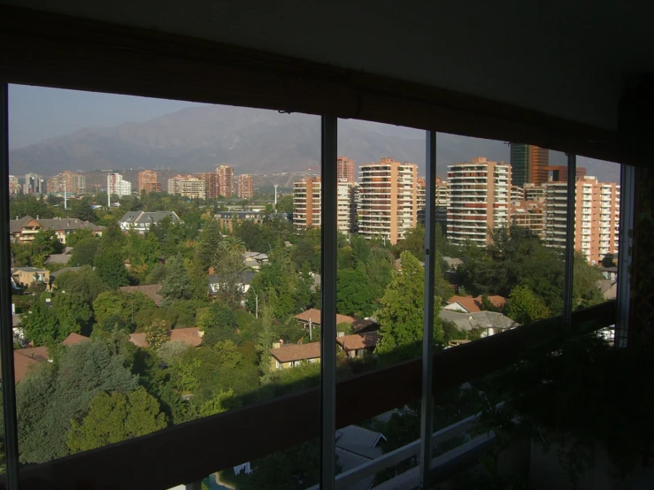 a balcony with tall buildings and trees in the background