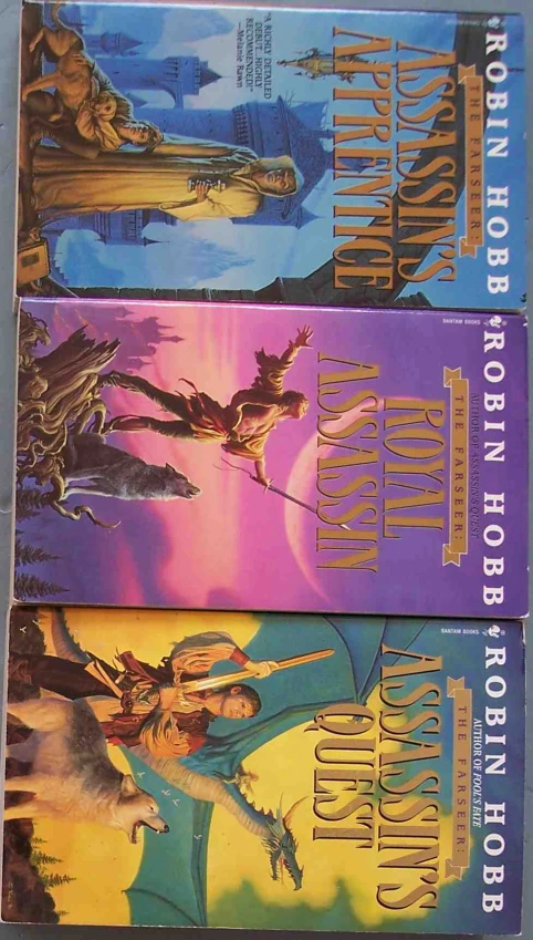 four books about fantasy and adventure are sitting on a shelf