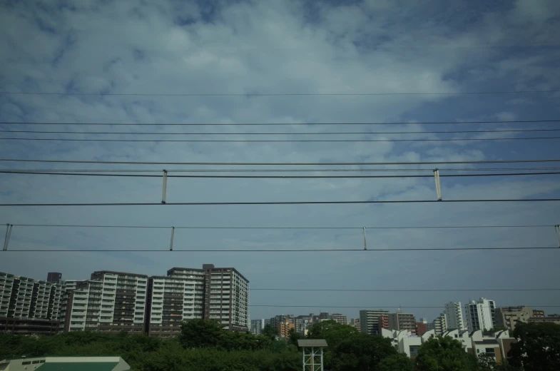 some power lines running over a city with high rise buildings