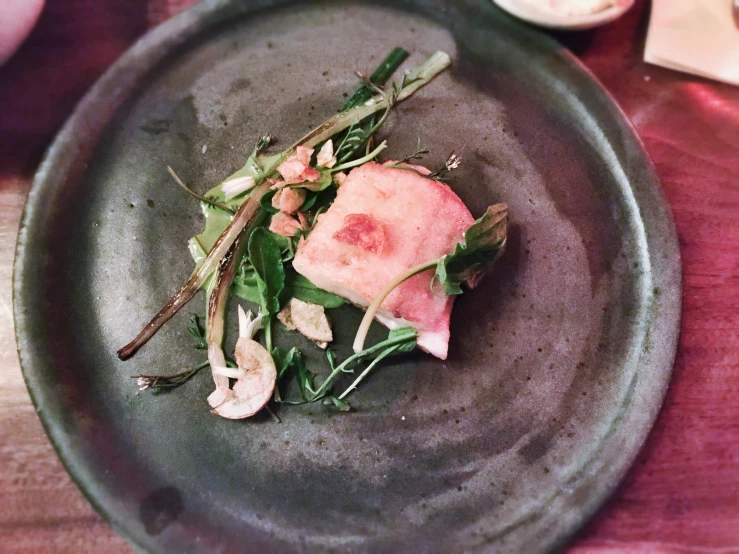 a plate with food on a wooden table