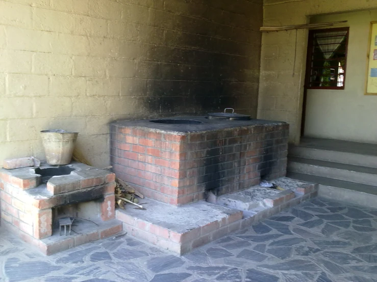 an outdoor area with brick fireplace and steps