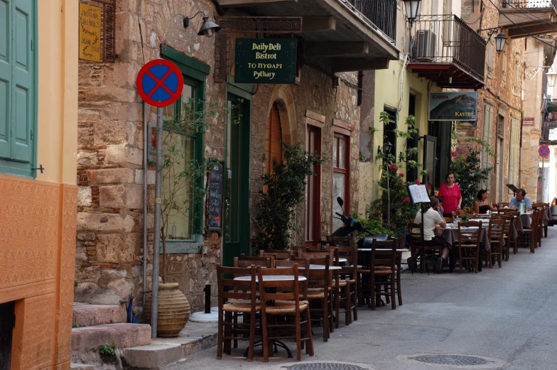 several wooden tables and chairs outside a restaurant